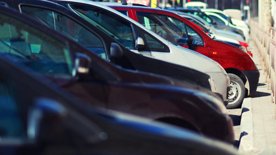 Lot of cars parking in the city, view side