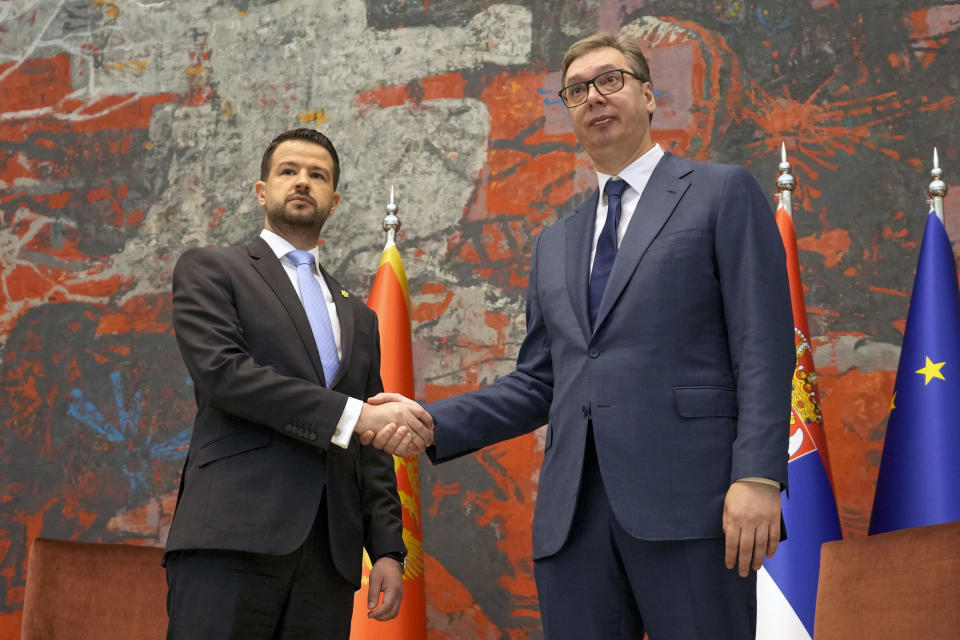 Montenegro's President Jakov Milatovic, left, shakes hands with his Serbian counterpart Aleksandar Vucic at the Serbia Palace in Belgrade, Serbia, Monday, July 10, 2023. Milatovic is on a two-day official visit to Serbia. (AP Photo/Darko Vojinovic)