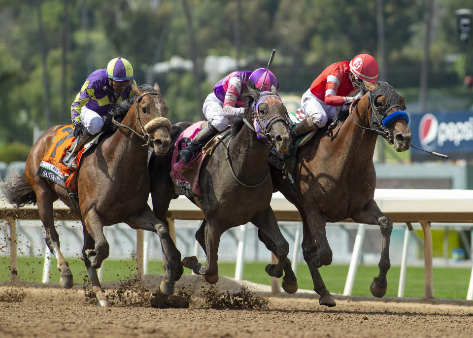 In a photo provided by Benoit Photo, Practical Move and jockey Ramon Vazquez, right, nose out Mandarin Hero, middle, with Kazushi Kimura, and Skinner, left, with Victor Espinoza, for victory in the Grade I, $750,000 Santa Anita Derby horse race Saturday, April 8, 2023, at Santa Anita in Arcadia, Calif. (Benoit Photo via AP)