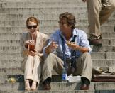 <p>Pierce Brosnan and Moore share a laugh while filming the 2004 romantic comedy <em>Laws of Attraction</em>. The two play rival divorce lawyers who fall in love. </p>