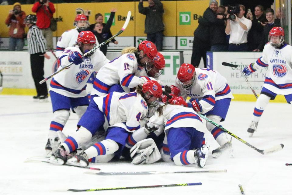 The Hartford Hurricanes storm the ice after their 5-3 win over Missisquoi in the D2 championship game at UVM's Gutterson Field House on Tuesday nighht.