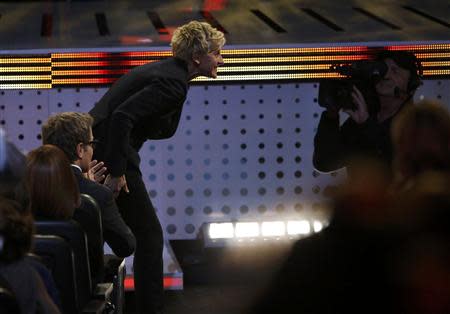 Ellen DeGeneres takes the stage to accept the award for favorite daytime tv host for her show "The Ellen DeGeneres Show" at the 2014 People's Choice Awards in Los Angeles, California January 8, 2014. REUTERS/Mario Anzuoni