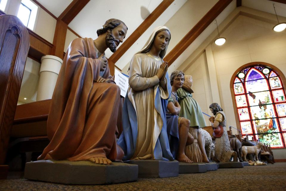 Figures for a nativity scene being set up at St. Matthew the Apostle Catholic Church in Gahanna are seen in December, with Joseph and Mary are in the foreground. The figures are about 100 years old and have been extensively repaired.