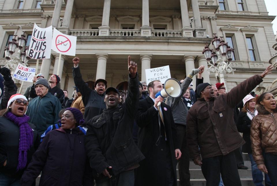 Protesters against right-to-work legislation chant "this is what democracy looks like" as they take to the steps of the Capitol in Lansing on Thursday, Dec. 6, 2012.