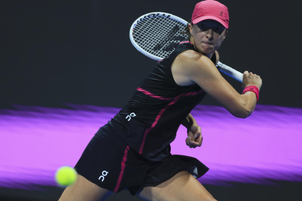 Poland's Iga Swiatek retruns to Kazakhstan's Ekaterina Rybakina during the Qatar Open final in Doha, Qatar, on Saturday, Feb. 17, 2024. (AP Photo/Hussein Sayed)