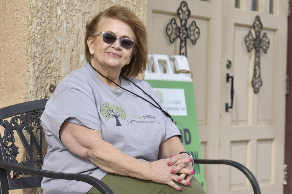 Liz Smith poses during a break from volunteer work in Sinclair, Wyo., on Wednesday, April 12, 2023. Smith, 67, helps organize and recruit volunteers at two food distribution locations in south central Wyoming. (AP Photo/Caroline Phillips)