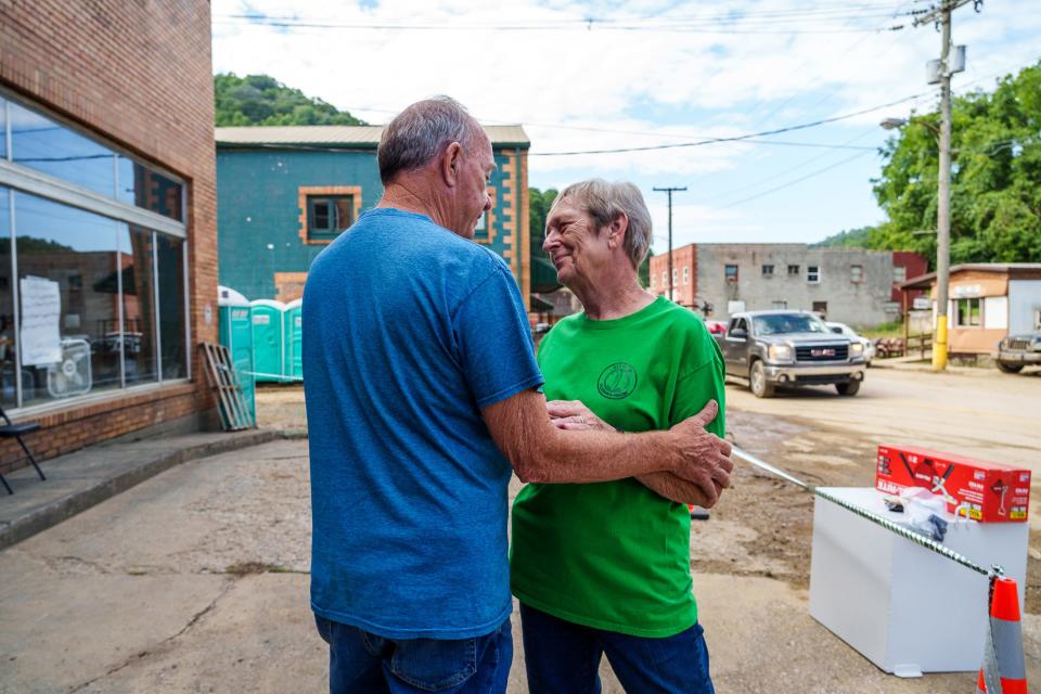 Phil Hensley tells Mayor Susan Polis to go get some rest Thursday, Aug. 4, 2022, outside a former business in Neon, Kentucky. Hensley, a former city manager from Pennington Gap, Virginia, has been assisting Polis with Federal Emergency Management Agency (FEMA) steps. "He's been with me since Saturday," she said. "If I didn't have him..." Polis began to tear up as she spoke of his help and giving heart. Polis has called the area home for 65 years. Her father also served as the town's Mayor.