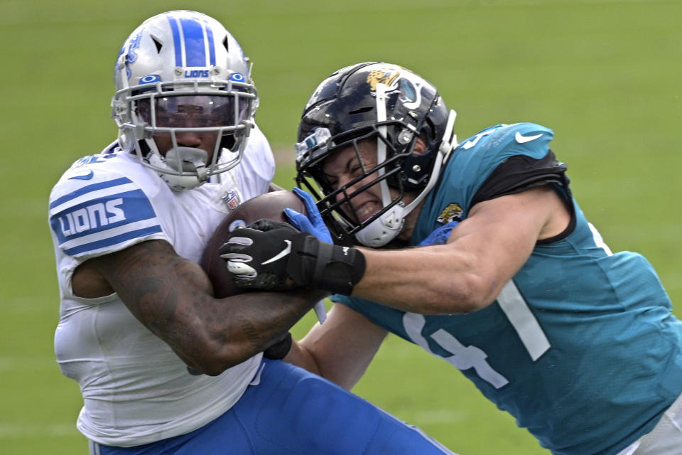 Detroit Lions running back D'Andre Swift, left, is tackled by Jacksonville Jaguars linebacker Joe Schobert after a short gain during the first half of an NFL football game, Sunday, Oct. 18, 2020, in Jacksonville, Fla. (AP Photo/Phelan M. Ebenhack)