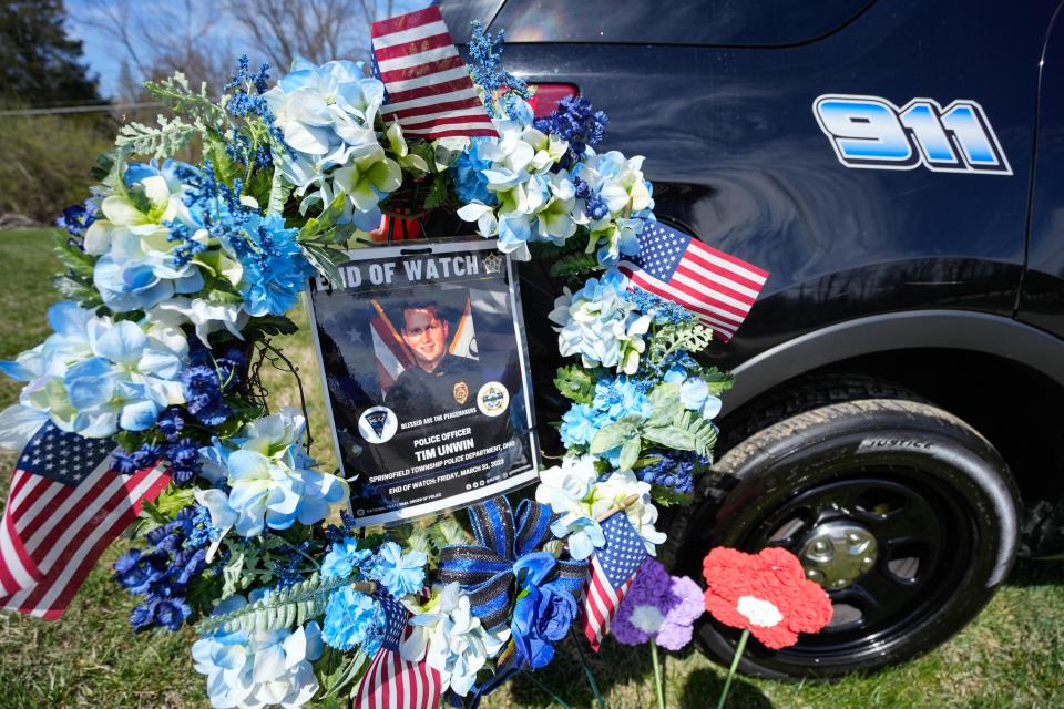 Memorials have shown up around the crash site and police station for Office Tim Unwin after he died in a double-fatal car crash Friday morning.