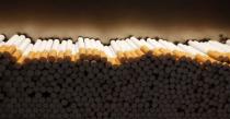 Cigarettes are piled during the manufacturing process in the British American Tobacco Cigarette Factory (BAT) in Bayreuth, southern Germany, in this April 30, 2014 file photograph. REUTERS/Michaela Rehle/Files