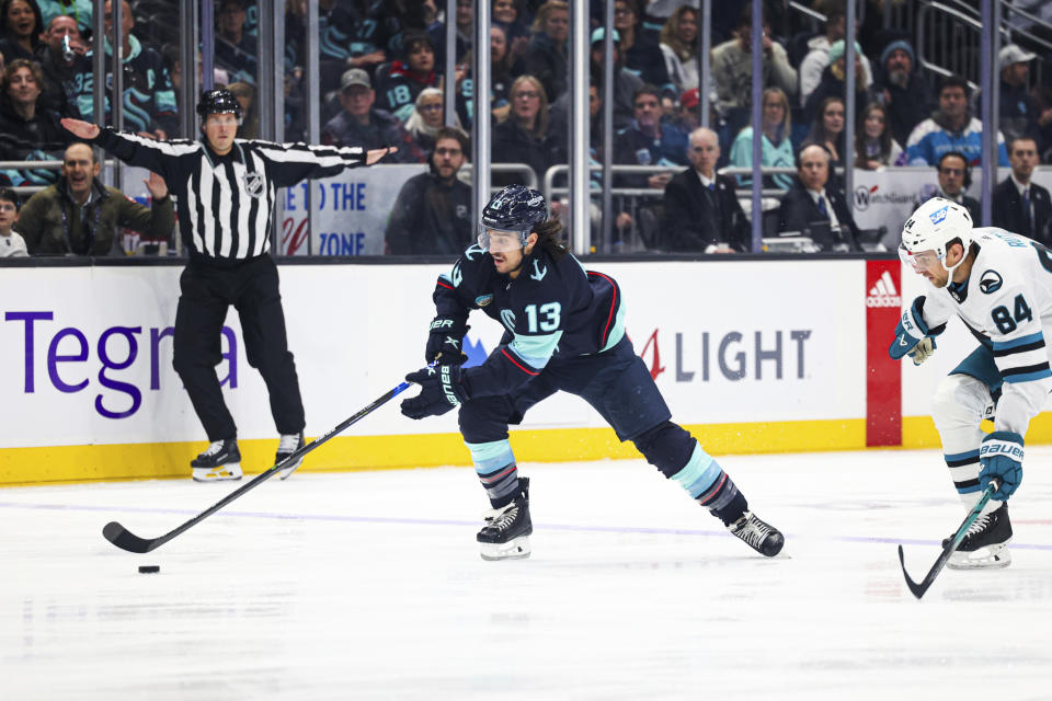 Seattle Kraken left wing Brandon Tanev skates towards the goal ahead of San Jose Sharks defenseman Jan Rutta during the first period of an NHL hockey game Wednesday, Nov. 22, 2023, in Seattle. (AP Photo/Maddy Grassy)