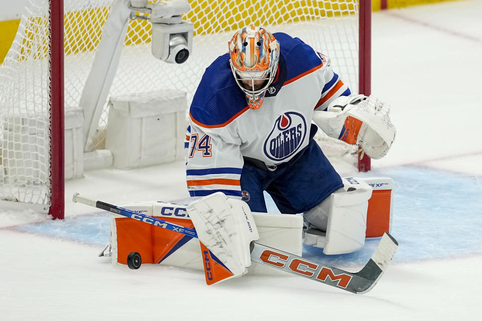 Edmonton Oilers goaltender Stuart Skinner (74) makes a save against the Dallas Stars during the third period in Game 1 of the NHL hockey Western Conference Stanley Cup playoff finals, Thursday, May 23, 2024, in Dallas. (AP Photo/Tony Gutierrez)