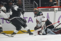 Arizona Coyotes goalie Karel Vejmelka (70) blocks a shot against Los Angeles Kings forward Phillip Danault (24) during the first period of an NHL hockey game Sunday, Nov. 21, 2021, in Los Angeles. (AP Photo/Ringo H.W. Chiu)