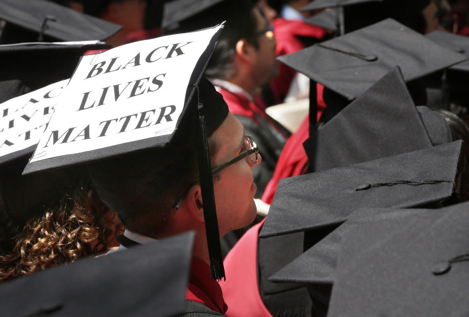 FILE - In this May 28, 2015, file photo, a graduate student of Harvard Law School displays the message "Black Lives Matter" on his mortar board during Harvard University commencement exercises in Cambridge, Mass. Black Lives Matter has gone mainstream — and black activists are carefully assessing how they should respond. (AP Photo/Steven Senne, File)