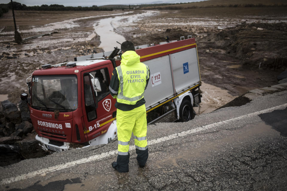 A firefighting truck is seen after crashing near the village of Campillos, Spain, where heavy rain and floods have caused severe damage and the death of a firefighter according to Spanish authorities, on Sunday, Oct. 21 2018. Emergency services for the southern region of Andalusia say that the firefighter went missing when his truck overturned on a flooded road during heavy rains that fell through the night, and his body was found after a search Sunday morning. (AP Photo/Javier Fergo)