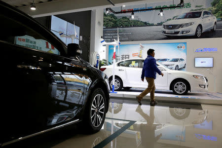 A man walks at an electric car dealership in Shanghai, China, January 11, 2017. REUTERS/Aly Song