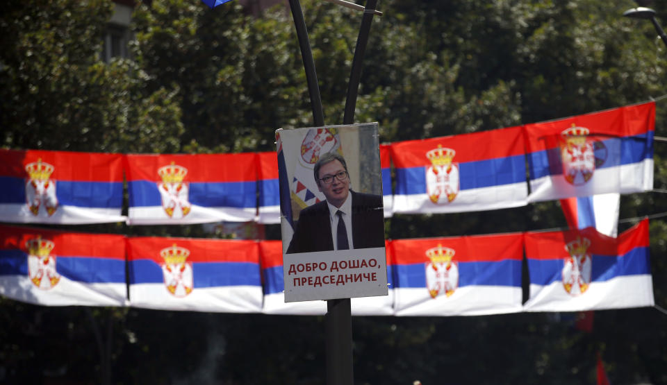 A poster showing Serbian President Aleksandar Vucic reading '"Welcome, President" and Serbian flags is seen during a rally in the northern, Serb-dominated part of Mitrovica, Kosovo, Sunday, Sept. 9, 2018. NATO-led peacekeepers in Kosovo say the safety of Serbia President Aleksandar Vucic during a visit to Kosovo isn't threatened despite roadblocks that prevented his visit to a central Serb-populated village. (AP Photo/Darko Vojinovic)