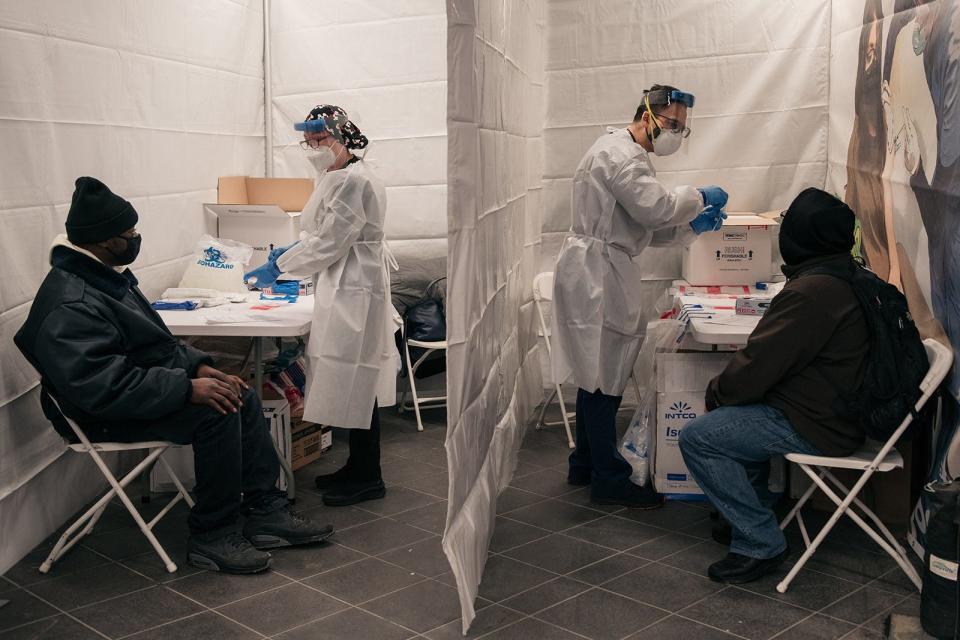 Medical workers prepare COVID-19 tests at a new testing site inside the Times Square subway station on Dec. 27, 2021, in New York City. (Scott Heins/Getty Images/TNS)