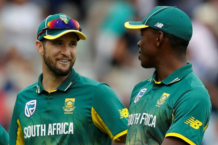 South Africa's Wayne Parnell (L) and South Africa's Kagiso Rabada leave the field after dismissing England for 153 on the third One-Day International cricket match between England and South Africa at Lord's Cricket Ground in London on May 29, 2017