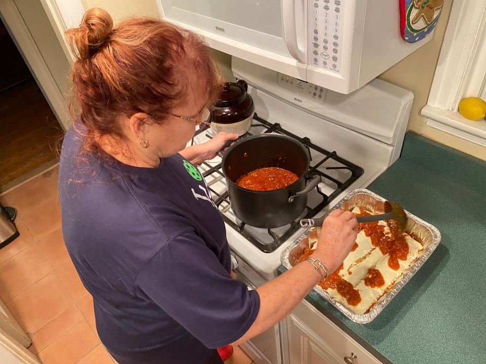 Lasagna Love volunteer Vickie Tully prepares a lasagna for the oven in her small Bellefonte kitchen on Thursday, Jan. 25.