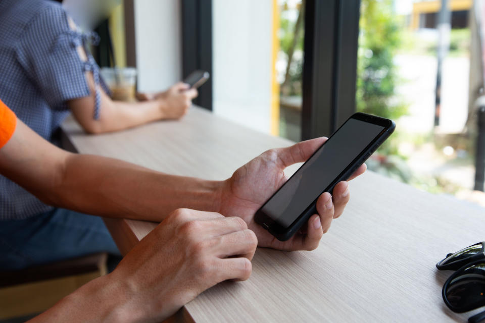 Businessman hand working with mobile phon on workplace in office.concept