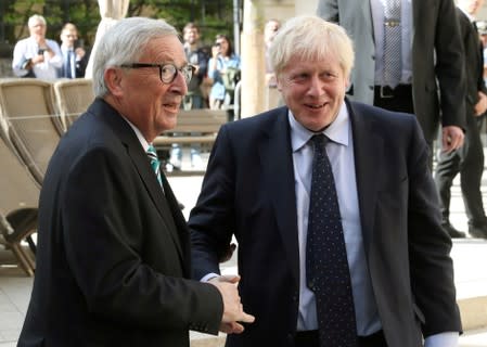 British Prime Minister Boris Johnson shakes hands with European Commission President Jean-Claude Juncker during a meeting in Luxembourg