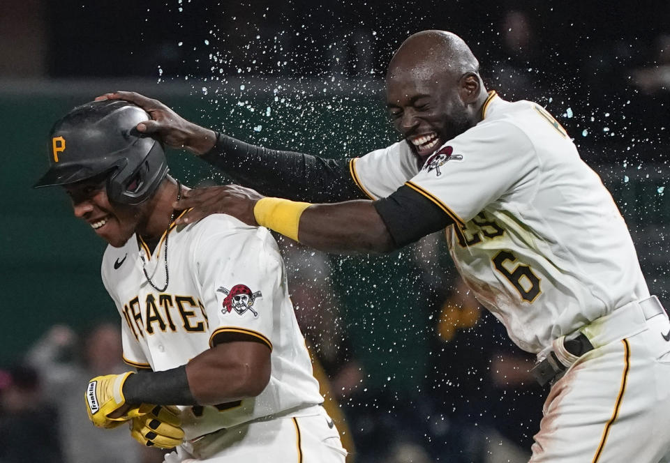 Pittsburgh Pirates' Ke'Bryan Hayes, left, celebrates with Anthony Alford after driving in the winning run in the team's baseball game against the Washington Nationals, Friday, Sept. 10, 2021, in Pittsburgh. The Pirates won 4-3. (AP Photo/Keith Srakocic)