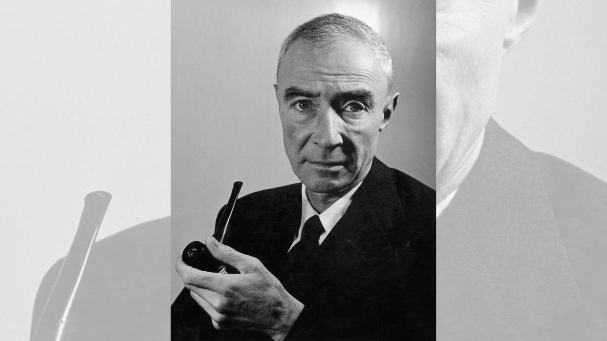  A portrait of J. Robert Oppenheimer holding a pipe 