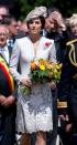 <p>In a Catherine Walker coat and holding a bouquet of flowers at the Passchendaele Commemorations in Belgium.</p>