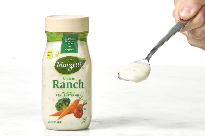 shot of Marzetti classic buttermilk ranch in the bottle and on a spoon.