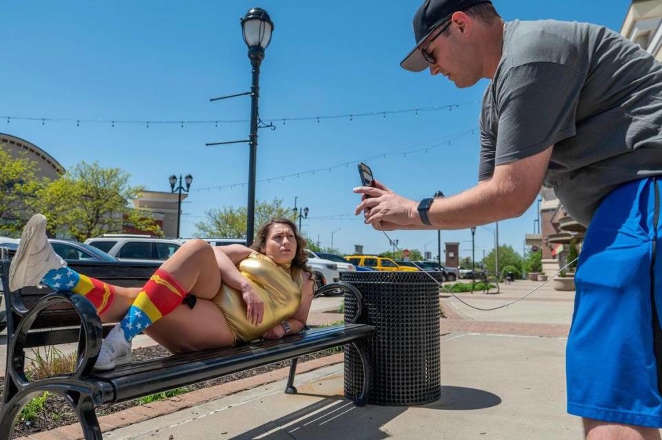 Wykert’s husband, Daniel Sanders, is her cameraman. Here they shot a recent video in a St. Joseph shopping area during the busy lunch hour.