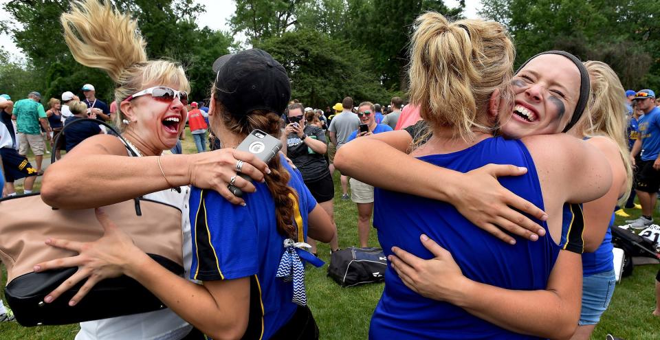 Kelly Reeves (left) leaps for joy and hugs her niece Taylor Wegener of Ida while her mother Kim Wegener hugs her other daughter Whitney Wegener after the Ida softball team came from behind to beat Richmond 8-4 in nine innings in the Division 2 State Finals at Michigan State University on June 17, 2017.