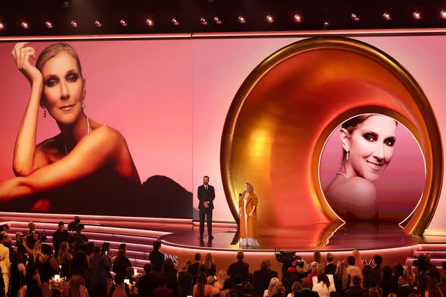 <p>Christopher Polk/Billboard via Getty</p> Céline Dion speaks onstage at the 66th Annual Grammy Awards.