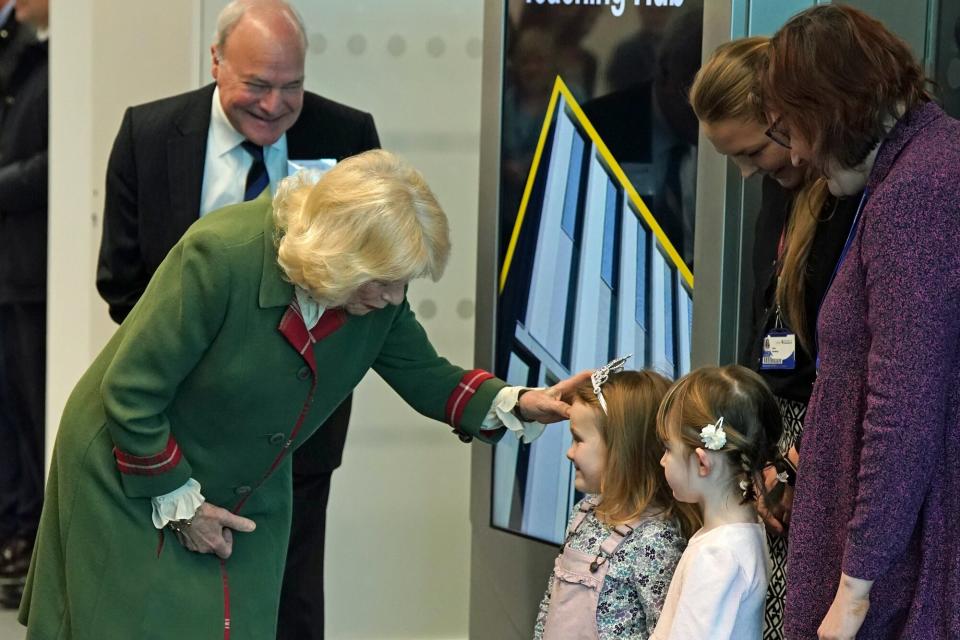 Camilla, Queen Consort, Chancellor of the University of Aberdeen, receives a bouquet of flowers from (left to right) Elspeth Cameron and Rosa Alexander both aged four from the Rocking Horse Nursey as she leaves after her visit to the university's new Science Teaching Hub to view demonstrations in the University's labs and meet staff and students on January 18, 2023 in Aberdeen, Scotland.