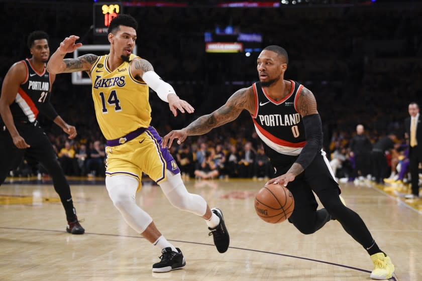 Portland guard Damian Lillard drives against the Lakers' Danny Green on Jan. 31, 2020.