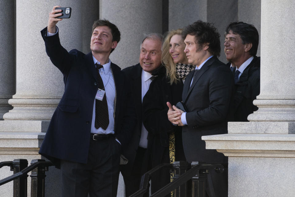 Argentina's President-elect Javier Milei poses for a photo on the steps of the Eisenhower Executive Office Building on the White House campus after a meeting with National Security Adviser Jake Sullivan, Tuesday, Nov. 28, 2023, in Washington. (AP Photo/Evan Vucci)