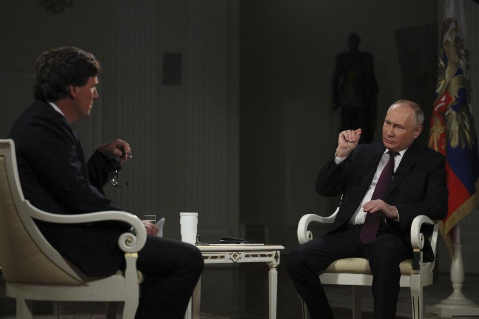 In this photo released by Sputnik news agency on Friday, Feb. 9, 2024, Russian President Vladimir Putin, right, speaks during an interview with former Fox News host Tucker Carlson at the Kremlin in Moscow, Russia, Tuesday, Feb. 6, 2024. (Gavriil Grigorov/Sputnik, Kremlin, Pool Photo via AP)