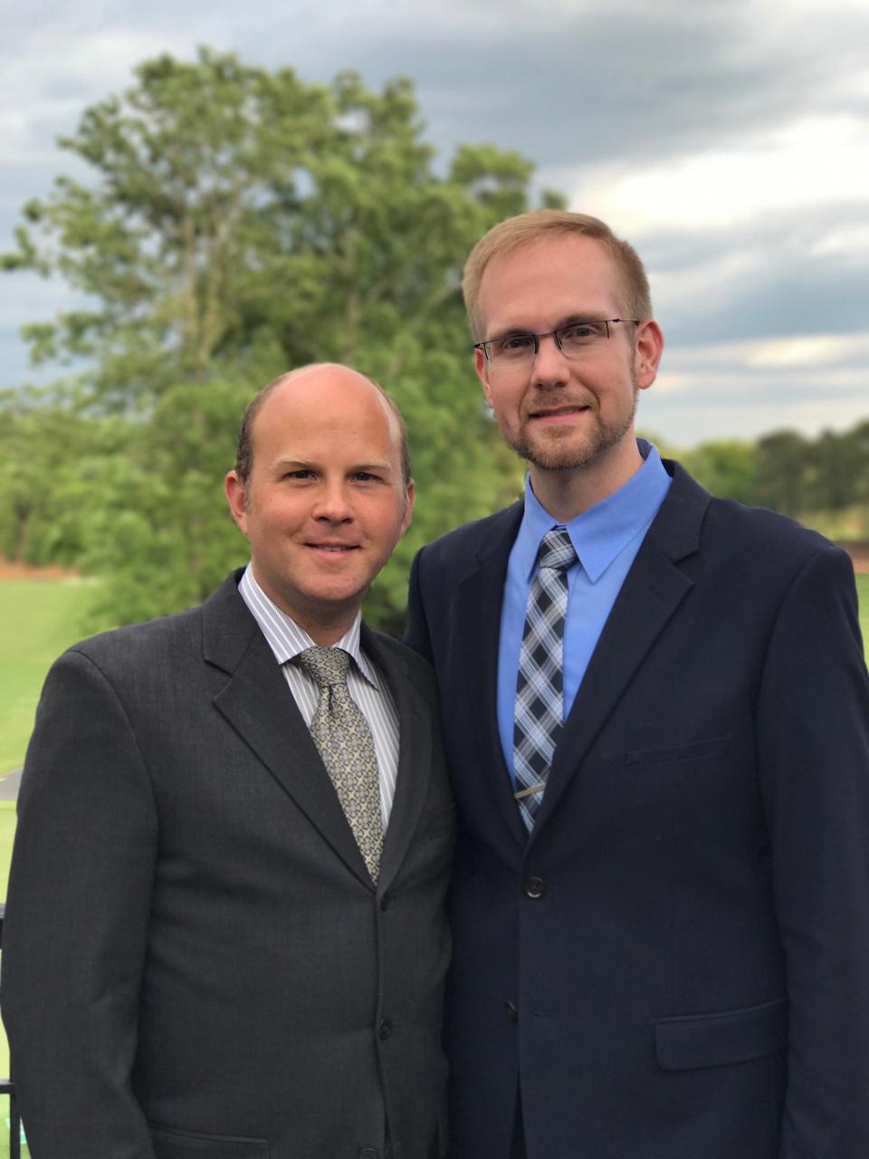 Joshua Payne-Elliot (right), pictured with his husband Layton Payne-Elliott, is suing the Archdiocese of Indianapolis.