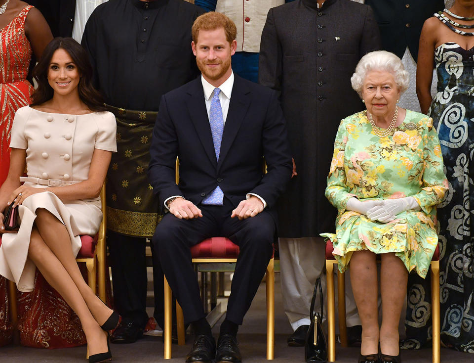 Meghan Markle sits with Prince Harry and the Queen