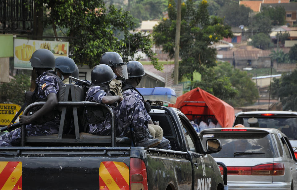 Ugandan riot police patrol on the streets of the Kamwokya neighborhood where pop star-turned-opposition lawmaker Bobi Wine, whose real name is Kyagulanyi Ssentamu, has his recording studio and many supporters, in Kampala, Uganda Thursday, Sept. 20, 2018. Security forces took Bobi Wine into custody when he arrived from the United States on Thursday, angering his supporters, while authorities barred public gatherings. (AP Photo/Ronald Kabuubi)