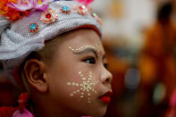 A boy waits inside Wat Klang Thung temple in preparation for an annual Poy Sang Long procession, part of the traditional rite of passage for boys to be initiated as Buddhist novices, in Mae Hong Son, Thailand, April 5, 2018. REUTERS/Jorge Silva