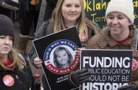 <p>Teacher Emily Mercer of Moore, Okla., holds a protest sign at the state Capitol on April 2, 2018, in Oklahoma City. (Photo: J Pat Carter/Getty Images) </p>