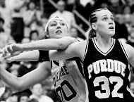 Purdues Katie Douglas battles Notre Dames Ruth Riley for rebounding position during Sunday nights NCAA championship game in St. Louis. AP photo