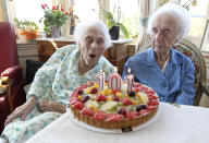 Marie (L) and Gabrielle (R) Vaudremer, 101-year-old Belgian twins, celebrate their birthday at the Chateau Sous-Bois retirement home in Spa October 2, 2011. Marie and Gabrielle were born in 1910 and are the world's oldest pair of twin sisters, according to the Guinness World Records. REUTERS/Thierry Roge