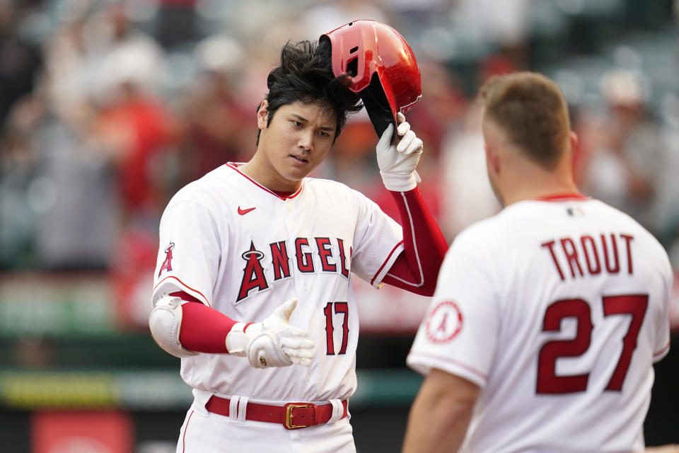 Los Angeles Angels designated hitter Shohei Ohtani (17) is greeted by Mike Trout (27) after hitting a home run during the seventh inning of a baseball game against the Detroit Tigers in Anaheim, Calif., Wednesday, Sept. 7, 2022. (AP Photo/Ashley Landis)