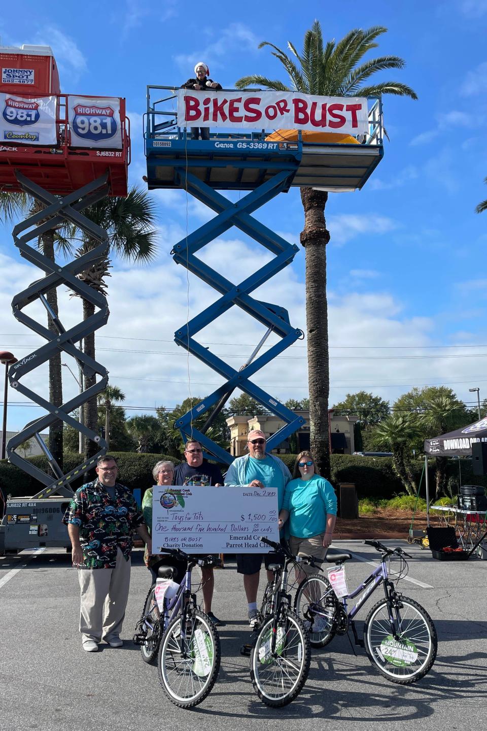 Members of the Emerald Coast Parrotthead Club were among the first to donate to "Bikes or Bust,"  an annual bicycle fundraiser put on by JVC Broadcasting's Highway 98 Country radio station. The event began Friday morning and runs through noon Tuesday, and on-air personality Bo Reynolds will spend 98 hours living atop this construction lift at Uptown Station in order encourage listeners to donate bicycles to Emerald Coast Toys for Tots.