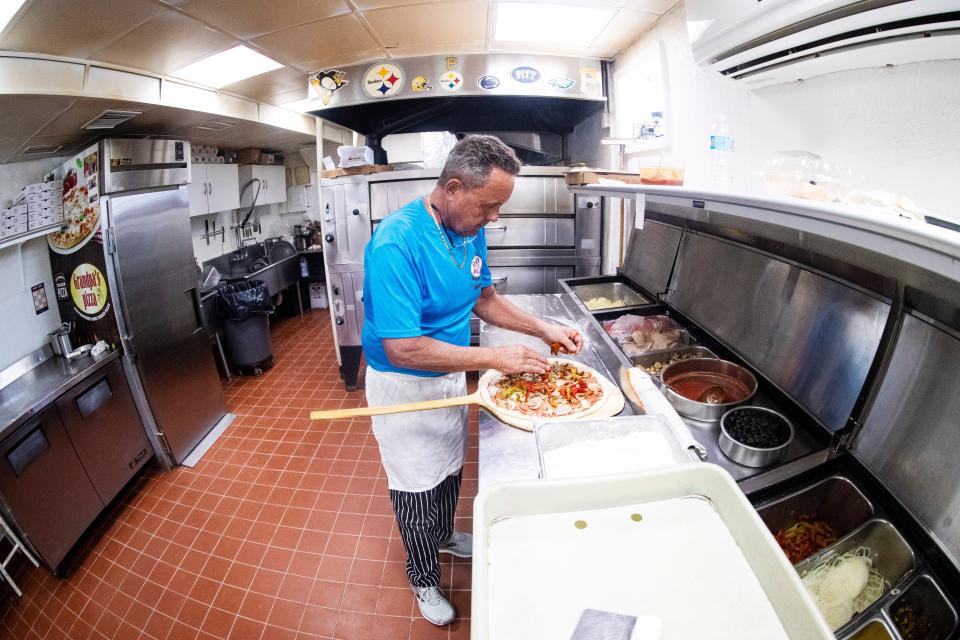 Joe Minetti, the owner of GrandpaÕs Pizza along Old U.S. 41 in Bonita Springs makes a pizza on March 19, 2024. A