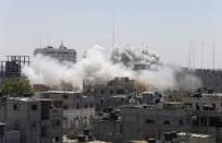 Smoke rises following what witnesses said were Israeli air strikes in Rafah in southern Gaza in this August 1, 2014 file photo. REUTERS/Ibraheem Abu Mustafa