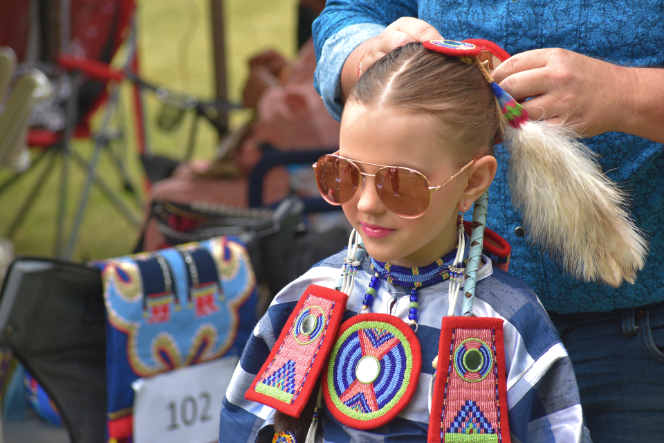 Brailynn Blevins, 9, stands still while her father, Wade, fixes her hair on Saturday, June 17, 2023.