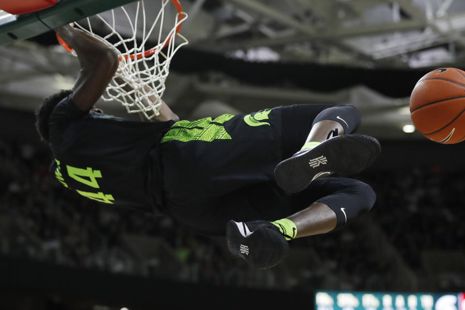 Michigan State forward Gabe Brown hangs from the rim after a dunk during the second half of an NCAA college basketball game against Wisconsin, Friday, Jan. 17, 2020, in East Lansing, Mich. (AP Photo/Carlos Osorio)